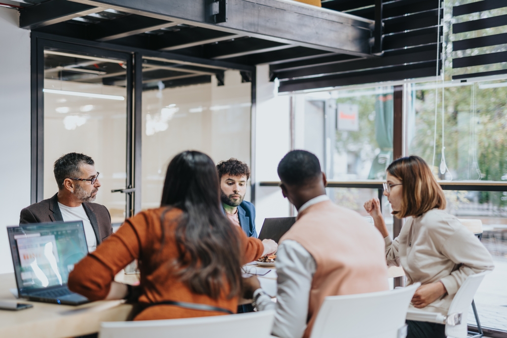 Team of professionals collaborating in a modern office, discussing business strategic planning.