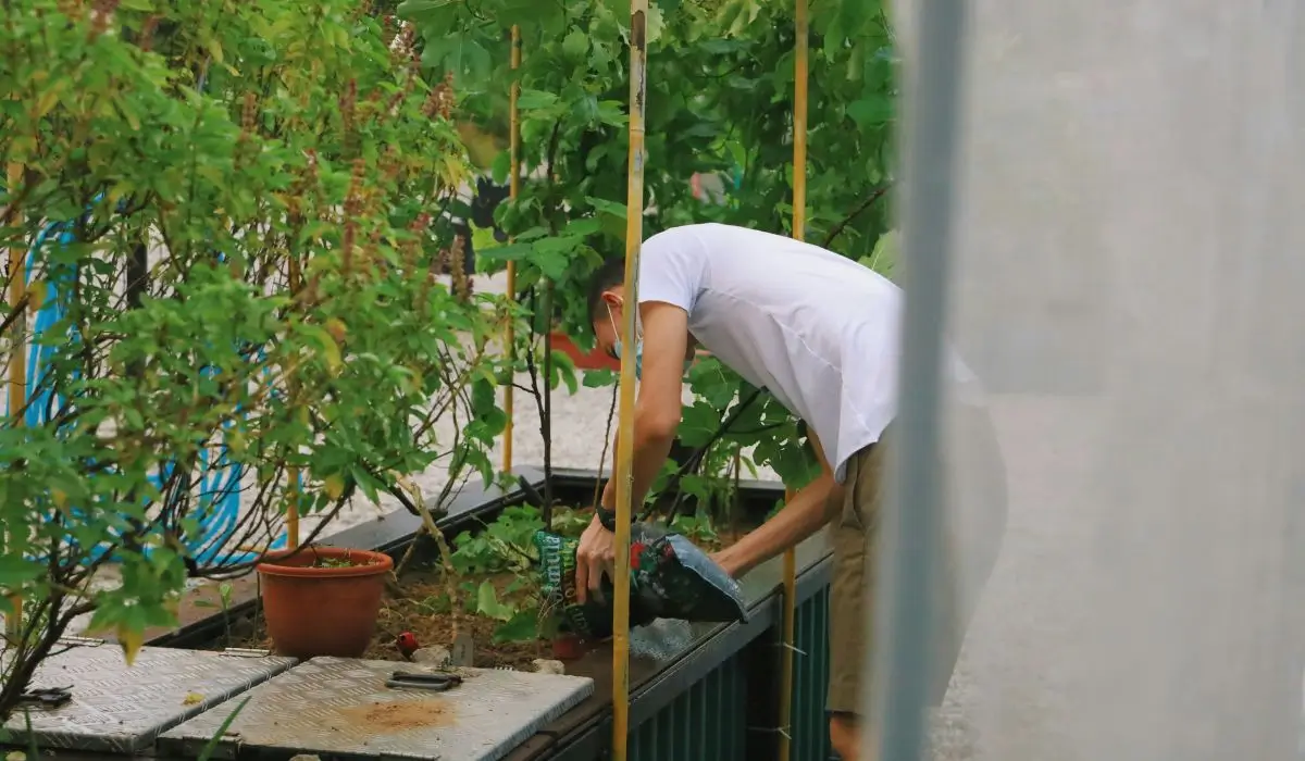 Student engaged in urban gardening as part of a grant-funded STEM program promoting environmental education.