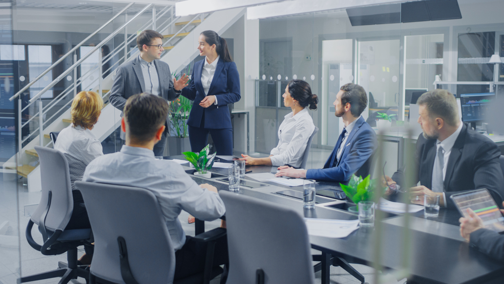 Business professionals collaborating in a meeting room, showcasing their industry expertise and strategic insights
