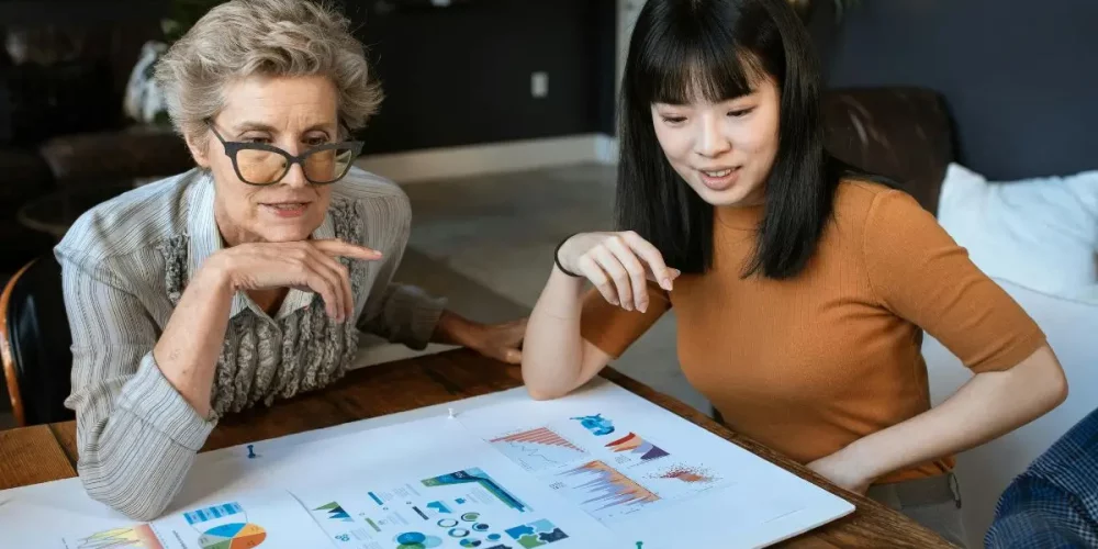 Two small business professionals reviewing charts generated by artificial intelligence for small business efficiency.